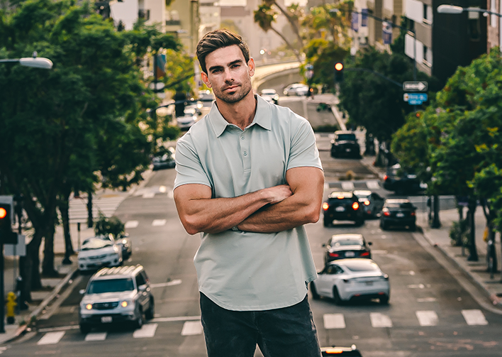 Drop-cut tee worn outdoors against green palms