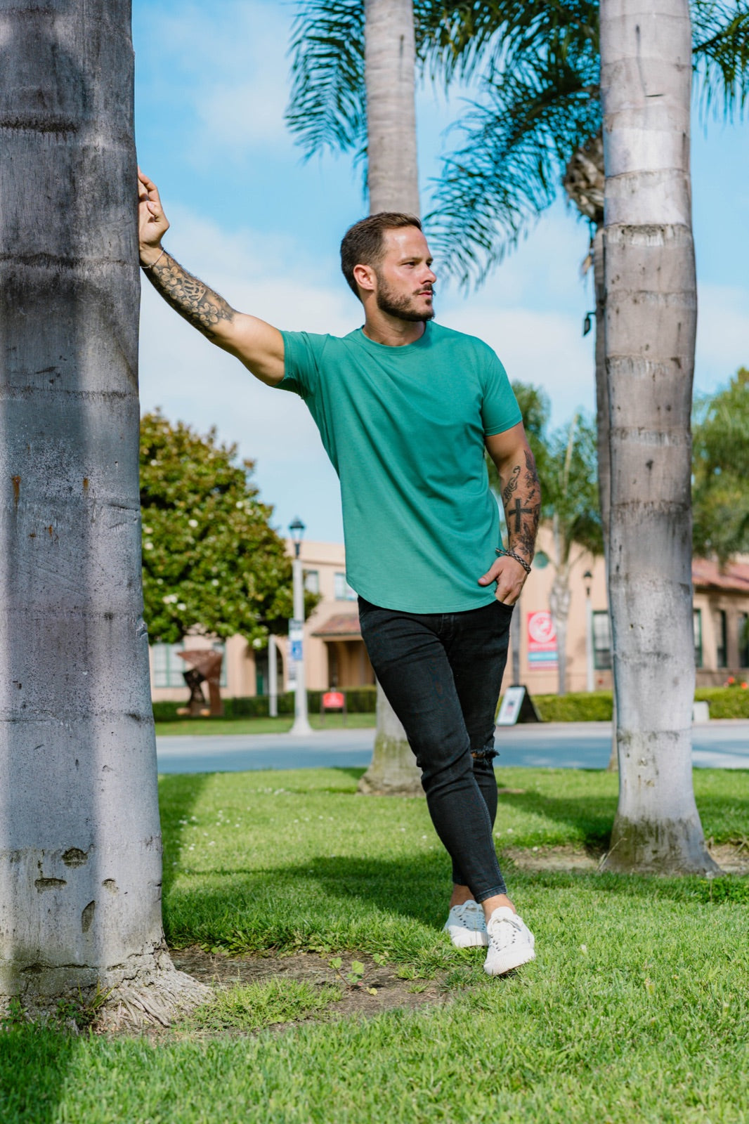 Drop-cut tee worn outdoors against green palms